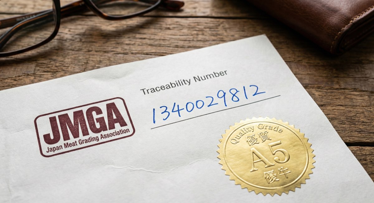 Person examining wagyu beef certificate on computer screen while shopping online - AI generated