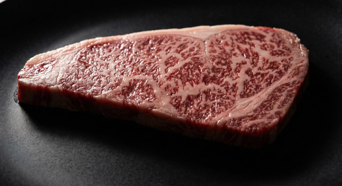 Side-by-side comparison of Kobe beef and Japanese A5 wagyu showing marbling patterns - Takeshi Nakamura for WagyuCompared.com